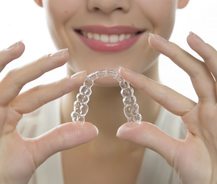 Dentist is checking up a patient with an ortodental system