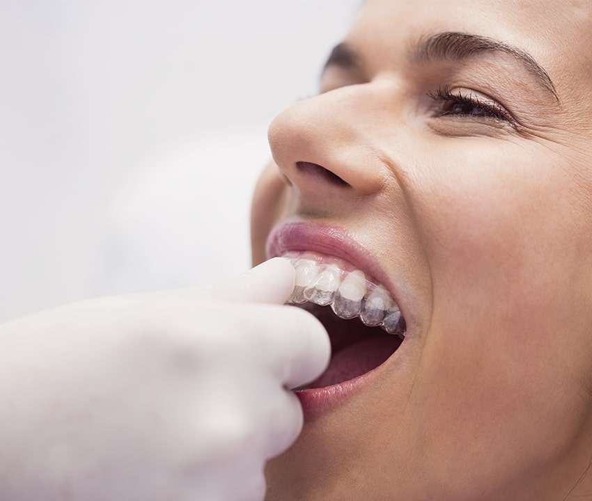 Dentist is checking up a patient with an ortodental system